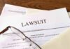 Legal documents labeled lawsuit on a desk