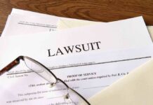 Legal documents labeled lawsuit on a desk