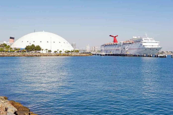 Cruise ship docked beside a large white domed building