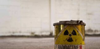 rusty metal can with radioactive warning symbol