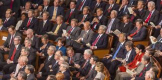 Rick Santorum, Samuel Bodman, Bob Bennett, La Parka, Mike Leavitt, Trent Lott, Saxby Chambliss, Richard Shelby, Spencer Abraham, Gordon H. Smith, Stephen Hadley, Richard M. Burr, Pat Roberts, John Cornyn, Joshua Bolten, Wayne Allard, Jerzy Eisler, Alphonso Jackson, John Warner, Mel Martinez, Olympia Snowe, David Vitter, Lindsey Graham, Johnny Isakson, Judd Gregg, John McCain, Andrew Card, Susan Collins, George Allen, Lincoln Chafee, Norm Coleman, Lamar Alexander, Richard Lugar seated in a large audience
