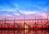 Electrical substation with power lines at sunset