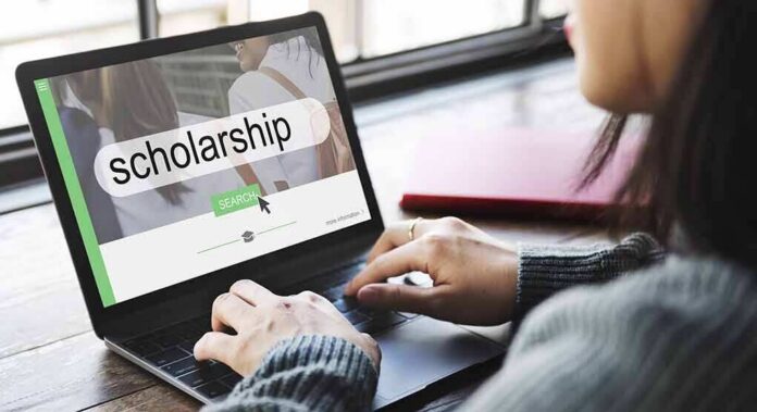 Person using a laptop to search for scholarships