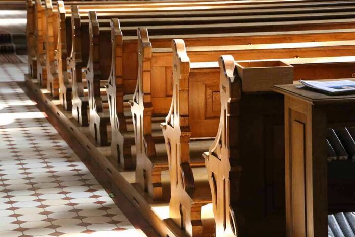 shutterstock_1152589436 wooden church pews in sunlight