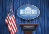 Donation Bombshell Triggers Sudden Ambassador Exit White House press briefing podium and US flag