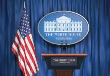 White House press briefing podium and US flag
