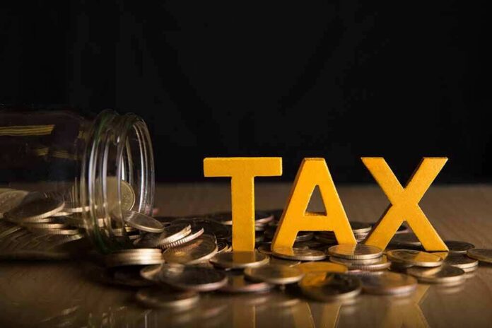 Yellow TAX letters among coins and a tipped jar
