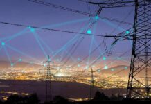 Undersea Cables Targeted – Internet At Risk Power transmission towers over a city at dusk with connected network lines