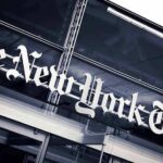 The New York Times sign on a glass building facade