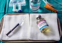 Medical tray with syringe and pentobarbital vials on gauze