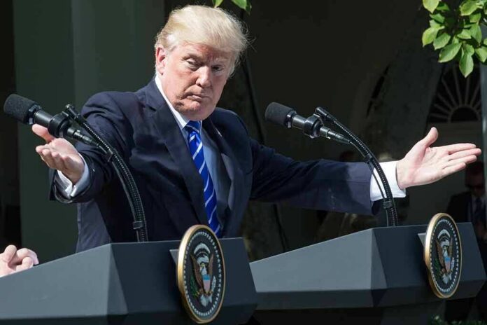 shutterstock_1456093781 Donald Trump speaking at dual podiums with arms outstretched
