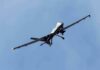 military drone flying in a clear blue sky
