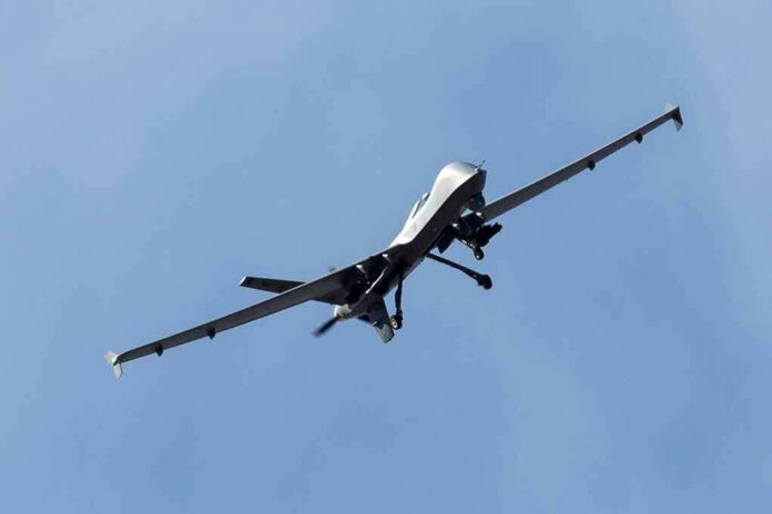 military drone flying in a clear blue sky