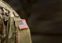 american flag patch on camouflage uniform sleeve