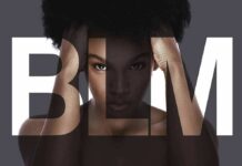 Woman with afro framed by large letters