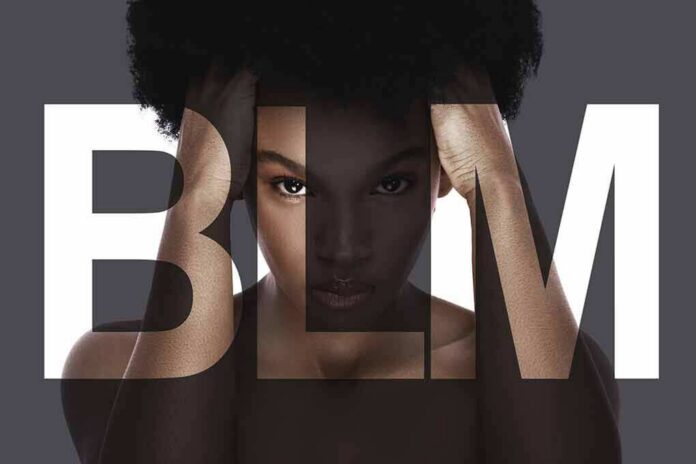 Woman with afro framed by large letters