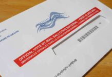 Mystery Mailers Stir South Carolina Congressional Race Mail-in ballot envelope with red label on wooden table