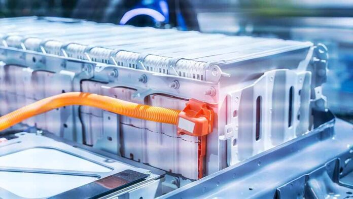 shutterstock_1801816357 Electric vehicle battery pack with orange high-voltage cable