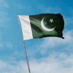 Pakistan Uproar: Coerced Conversion Alleged Pakistan flag waving against a blue sky