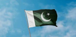Pakistan flag waving against a blue sky