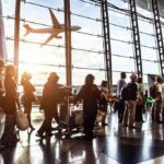 Mid-Air Mutiny: Israel Crash Plot Alleged Passengers queue inside an airport terminal at sunset