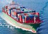 Red Sea Blockade Threat Rattles Traders A large cargo ship loaded with colorful containers sailing on the ocean