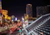 Las Vegas Strip at night with traffic and grandstand seating