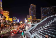 Las Vegas Strip at night with traffic and grandstand seating