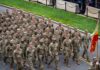Testosterone Crisis Looms Over Army Soldiers in camouflage uniforms march in formation on a street