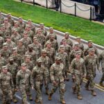 Testosterone Crisis Looms Over Army Soldiers in camouflage uniforms march in formation on a street