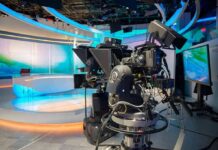 robotic television cameras on a modern news studio set