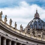 Vatican Clash Erupts Over Polygamy St. Peter's Basilica dome with statues along colonnade