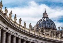 Vatican Clash Erupts Over Polygamy St. Peter's Basilica dome with statues along colonnade