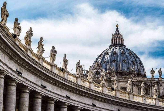 St. Peter's Basilica dome with statues along colonnade