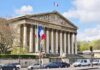 Neoclassical building with columns and French flags