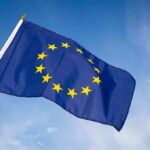 European Union flag waving against blue sky