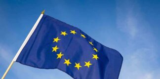 European Union flag waving against blue sky