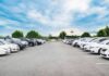 Campus Shock: Professor Hit With Felony Counts Parking lot lined with cars under a blue sky
